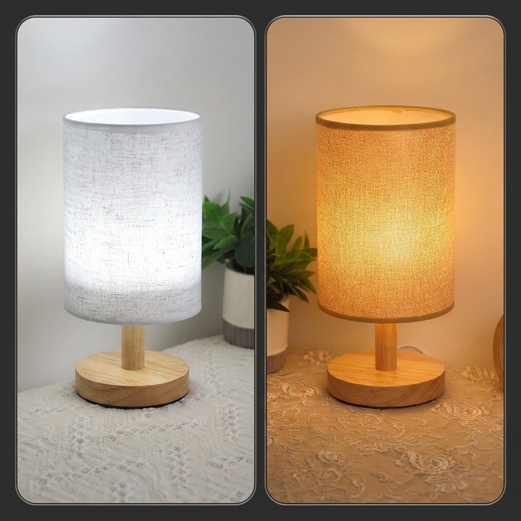 A split-screen view of a table lamp showing two light modes: on the left, the lamp glows with cool white light from a textured white fabric shade and a light wood base; on the right, it glows with warm yellow light under the same shade and base. Both are shown on a patterned beige tablecloth with a small potted plant in the background.