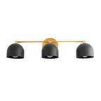 Modern wall light fixture with three black lampshades and gold accents on a white background