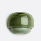 A glossy, dome-shaped wall sconce in a muted olive green color, shown against a plain light gray background.